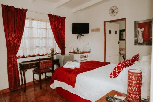 a bedroom with a bed and a desk with a computer at Gegund Guest Accomodation in Parys