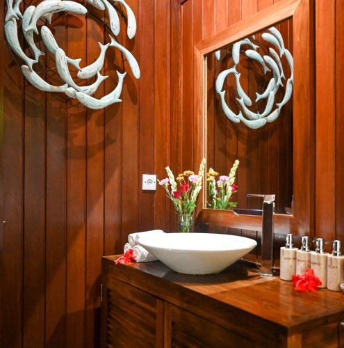 a bathroom with a sink and some antlers on the wall at Kaloi Villa in Bedahulu
