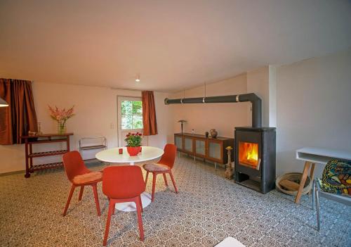 a living room with a table and a fireplace at Loft 4 in Schleiden