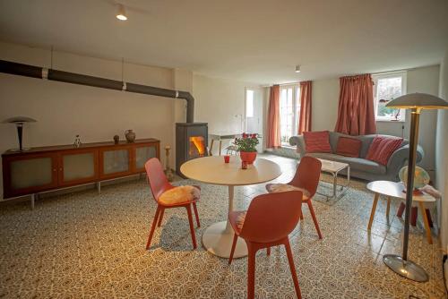 a living room with a table and chairs and a couch at Loft 4 in Schleiden