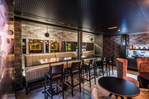a bar with tables and chairs in a restaurant at Pestana CR7 Lisboa in Lisbon