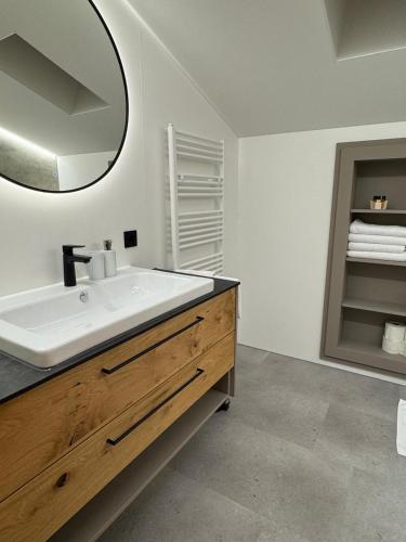 a bathroom with a sink and a mirror at Appartements Lenzikopf in Brand