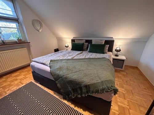 a bedroom with a large bed with green pillows at Vechte-Palais obere Wohnung in Metelen