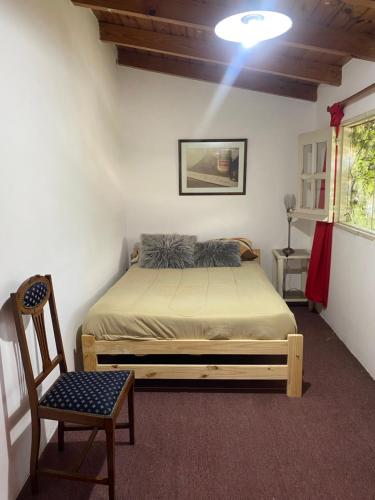 a bedroom with a bed and a chair in it at Felicidades in Rosario