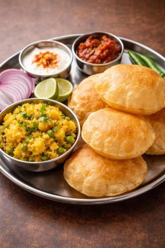 een bord met eten, koekjes en schalen met eten bij 4Everstay Grand Luxury Sambhala Premium Rooms Free Parking & Wifi !!! Top Rated & Best Selling Hotel In Manali in Manāli