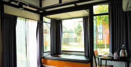 a large window in a room with a table at AKKARA RESORT&VILLA in Chiang Rai