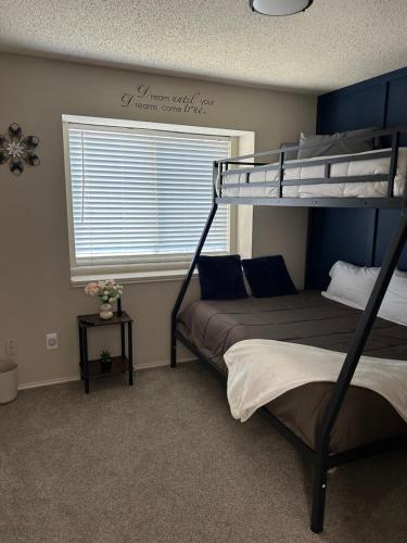 a bedroom with two bunk beds and a window at Rockwall Harbor Retreat in Rockwall