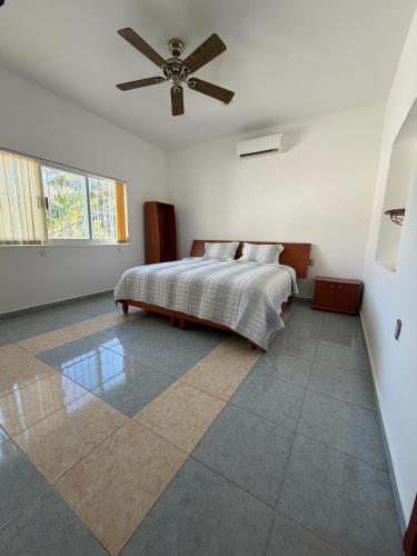 a bedroom with a bed and a ceiling fan at Casa Vemisa Puerto Escondido in Puerto Escondido