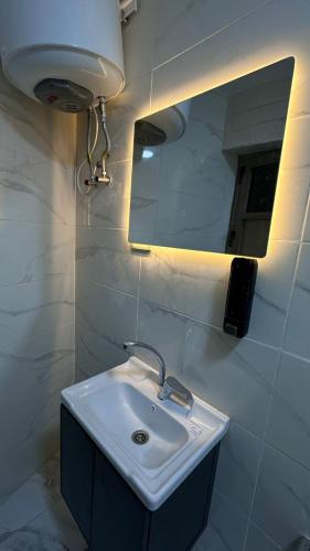 a bathroom with a sink and a mirror at Nadina Bedouin home in Petra