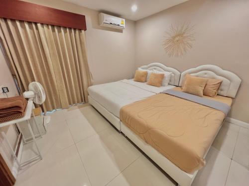 a bedroom with a bed and a desk in it at Seaview pool villa bangsaray in Bang Sare