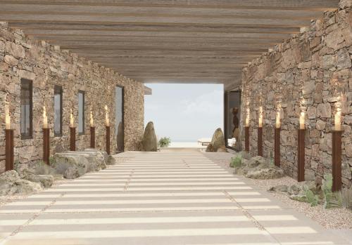 eine Steinmauer mit Beleuchtung auf einem Gehweg in der Unterkunft The Revery - Luxury Suites & Tented Pavilions, Elafonisi - Adults Friendly in Livadia