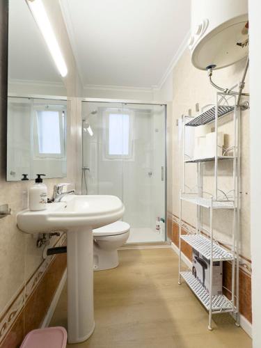 a bathroom with a sink and a toilet and a shower at Apartamento Nayara in Alcañiz