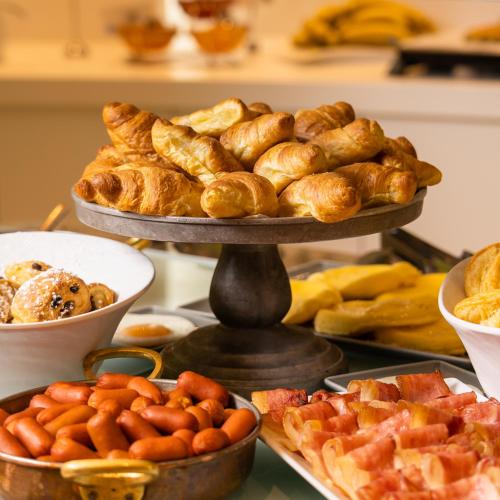 a table topped with a tray of pastries and other foods at Golden Star City Resort in Perea