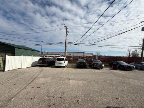 a parking lot with cars parked in front of a building at Delmar Loop 2-Bedroom Retreat in University City