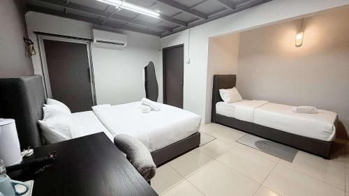 a hotel room with two beds and a couch at Gather inn in George Town