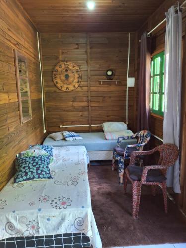 En eller flere senge i et værelse på Cabana aconchegante na natureza