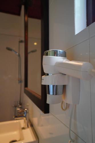 a bathroom with a sink and a mirror at Hideaway Lodge in Tangalle
