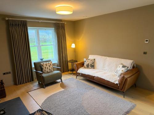 a living room with a couch and a chair at Cluain Alainn in Cashel