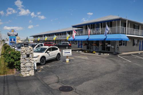 a white car parked in front of a building at Friendship Oceanfront Suites in Old Orchard Beach