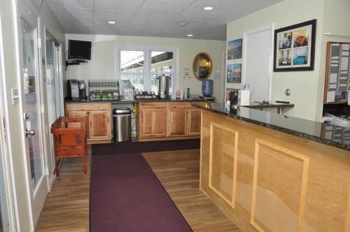 a kitchen with a counter and a counter top at Friendship Oceanfront Suites in Old Orchard Beach