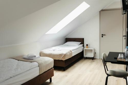 Postel nebo postele na pokoji v ubytování Wilczy Sen