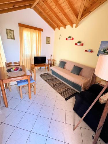 a living room with a couch and a table at Eva's Apartments in Karlovasi