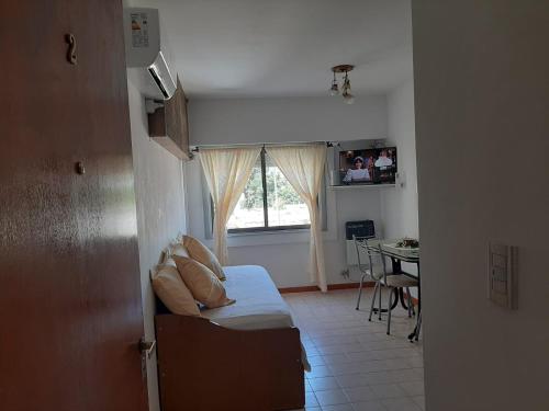 a living room with a couch and a window at Noche Serena in Puerto Madryn