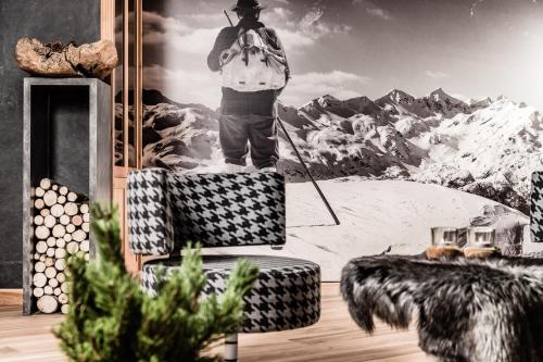 a man standing on top of a painting of a mountain at Josef Mountain Resort in Avelengo