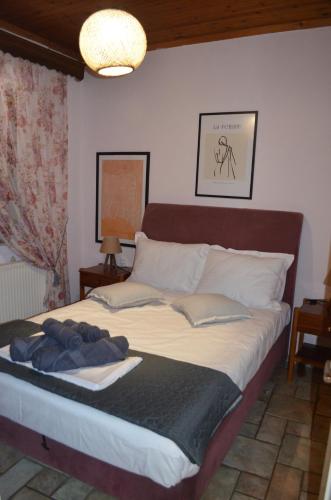 a bedroom with a large bed with white sheets at Soula's Cozy House in Kala Nera