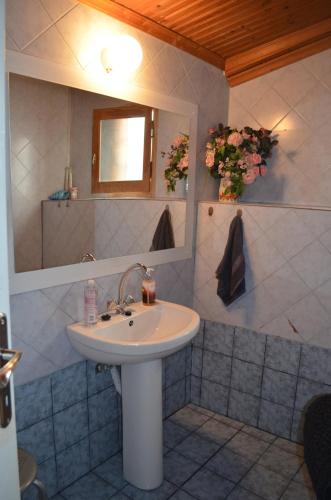 a bathroom with a sink and a mirror at Soula's Cozy House in Kala Nera
