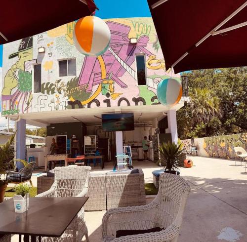 a building with a table and chairs and an umbrella at Atrium Star Wars-themed Design District in Miami
