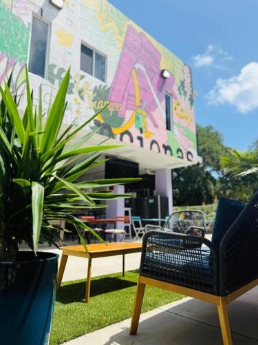 a group of chairs and plants in front of a building at Atrium Star Wars-themed Design District in Miami