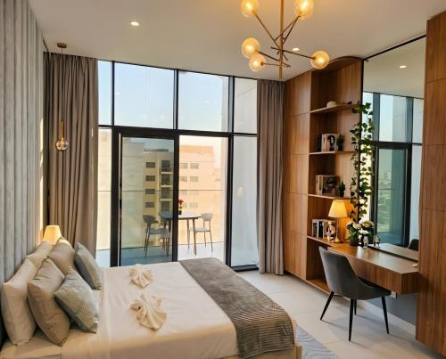 a bedroom with a large bed and a desk with a desk at Luxury Studio in Dubai in Dubai