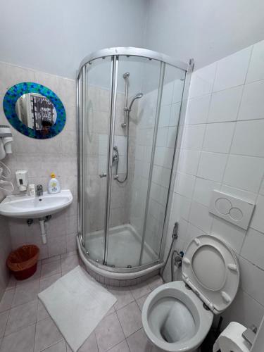 a bathroom with a shower and a toilet and a sink at Destination In Rome in Rome