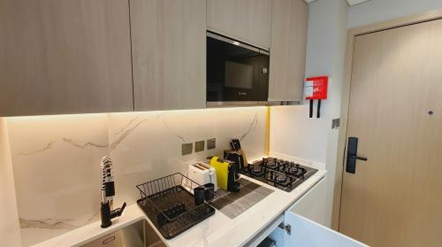 a kitchen with a stove and a counter top at Luxury Studio in Dubai in Dubai