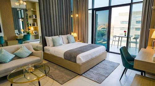 a bedroom with a bed and a couch and a table at Luxury Studio in Dubai in Dubai