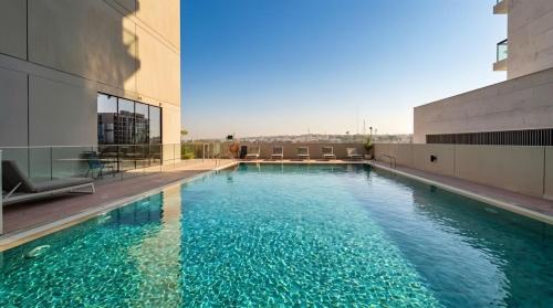 a swimming pool on the roof of a building at Luxury Studio in Dubai in Dubai