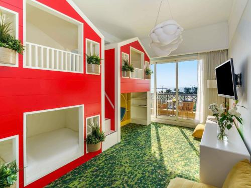 uma sala de estar com uma parede vermelha em Rixos Bab Al Bahr - Ultra All Inclusive em Ras al-Khaimah