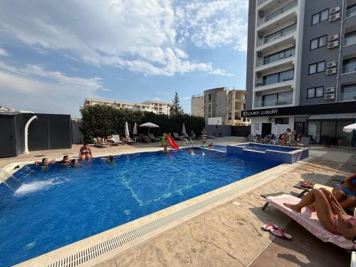 een groot zwembad met mensen in een hotel bij Hotel Lajka Luxury in Ulcinj