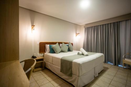 a bedroom with a large bed in a room at Baía Branca Beach Resort in Tamandaré