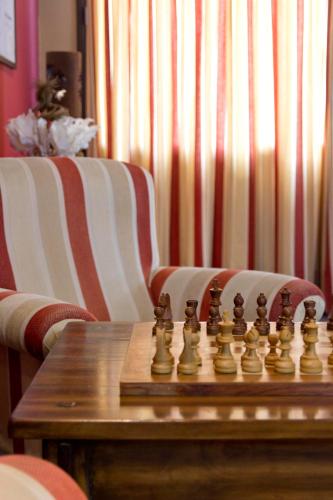 a chessboard is sitting on top of a wooden table at Aparthotel La Vall Blanca in Vielha