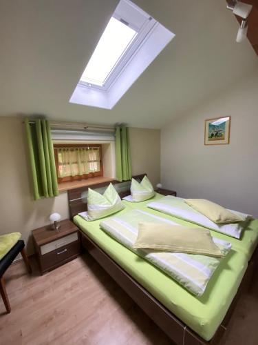 a bedroom with a large bed with a skylight at Ferienwohnung Elisabeth in Eggstätt
