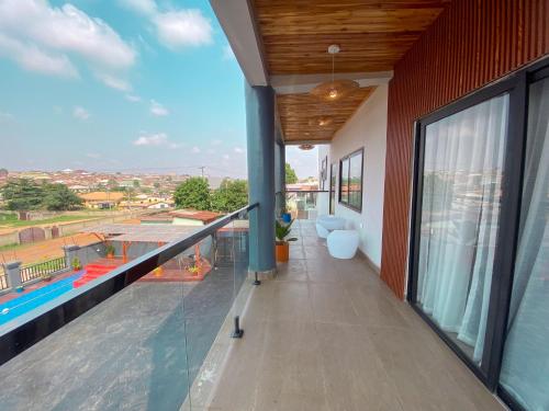 a balcony with a view of a swimming pool at EK'sPEAK in Kumasi