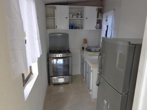 a small kitchen with a stove and a refrigerator at Posada Sweet Anashly in Providencia