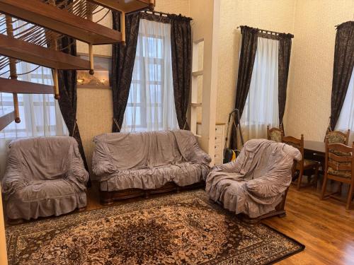 a living room with two beds and a table at Квартира in Chişinău
