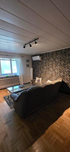 a living room with a large couch and a table at Villa Kjell in Vidsel