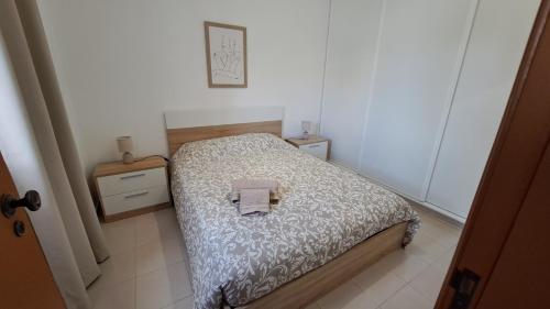 een kleine slaapkamer met een bed en twee nachtkastjes bij Cosy Vau in Vau