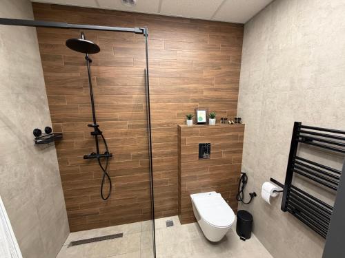 a bathroom with a shower and a toilet in it at Flora Hotel Apartment 103 in Borovets