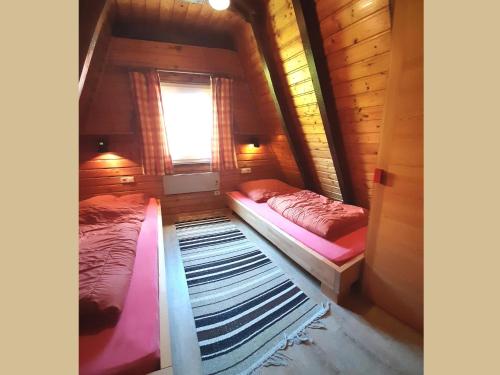 two beds in a small room with a window at Charmantes Ferienhaus in Skigebietsnaehe in Schmallenberg