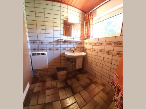 a bathroom with a sink and a toilet at Geraeumiges Apartment mit privater Terrasse in Schmallenberg